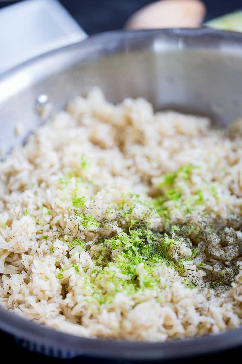 lemon zest and herbs on top of rice