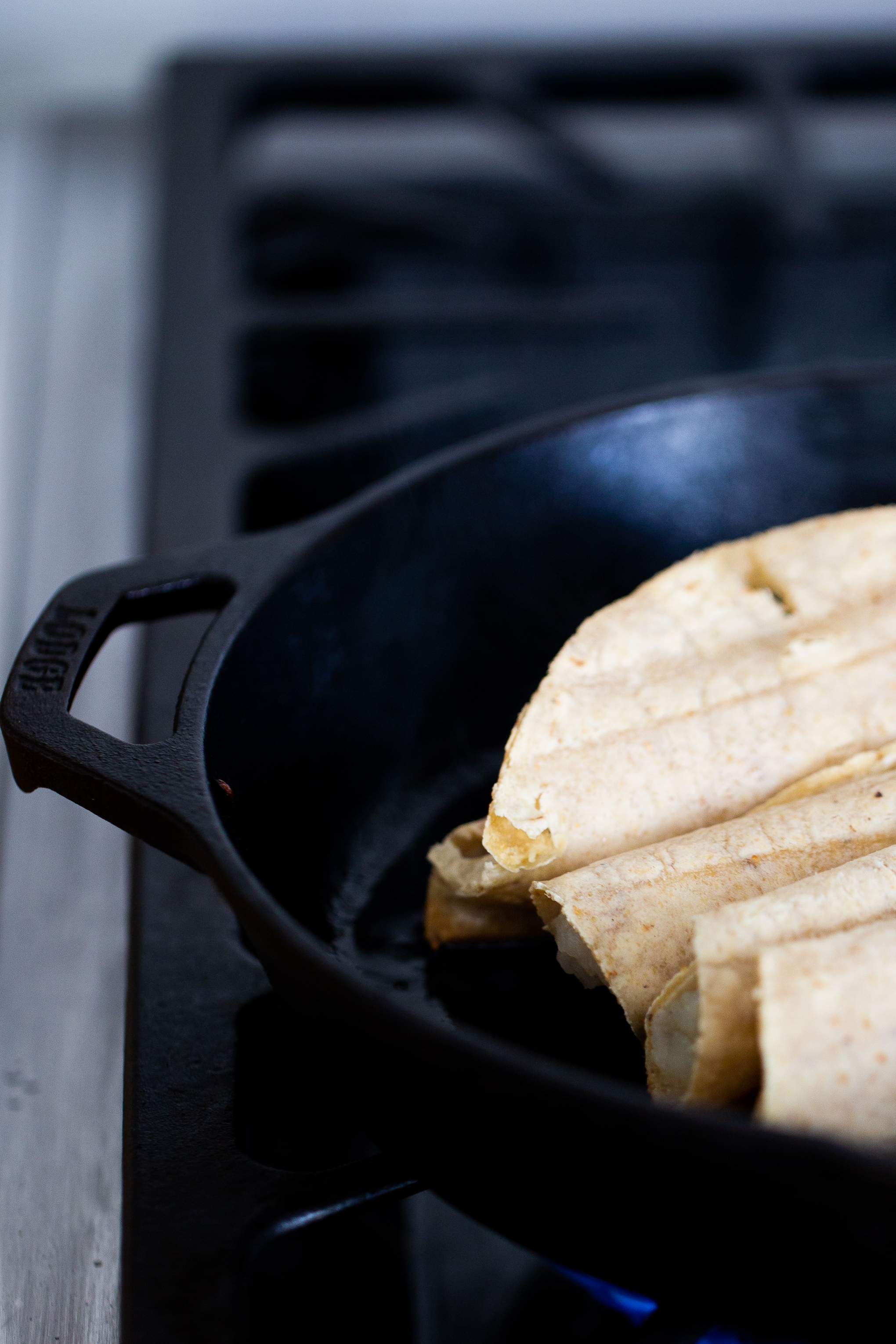 crispy potato tacos in a cast iron frying pan