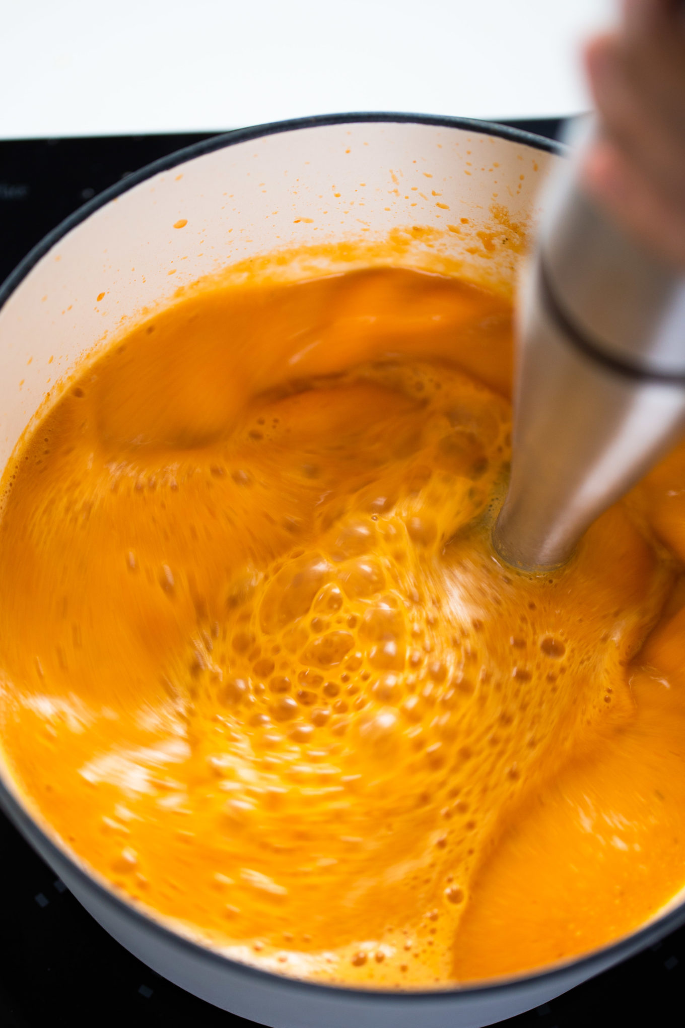 immersion blender in the dutch oven, oureeing the creamy tomato soup