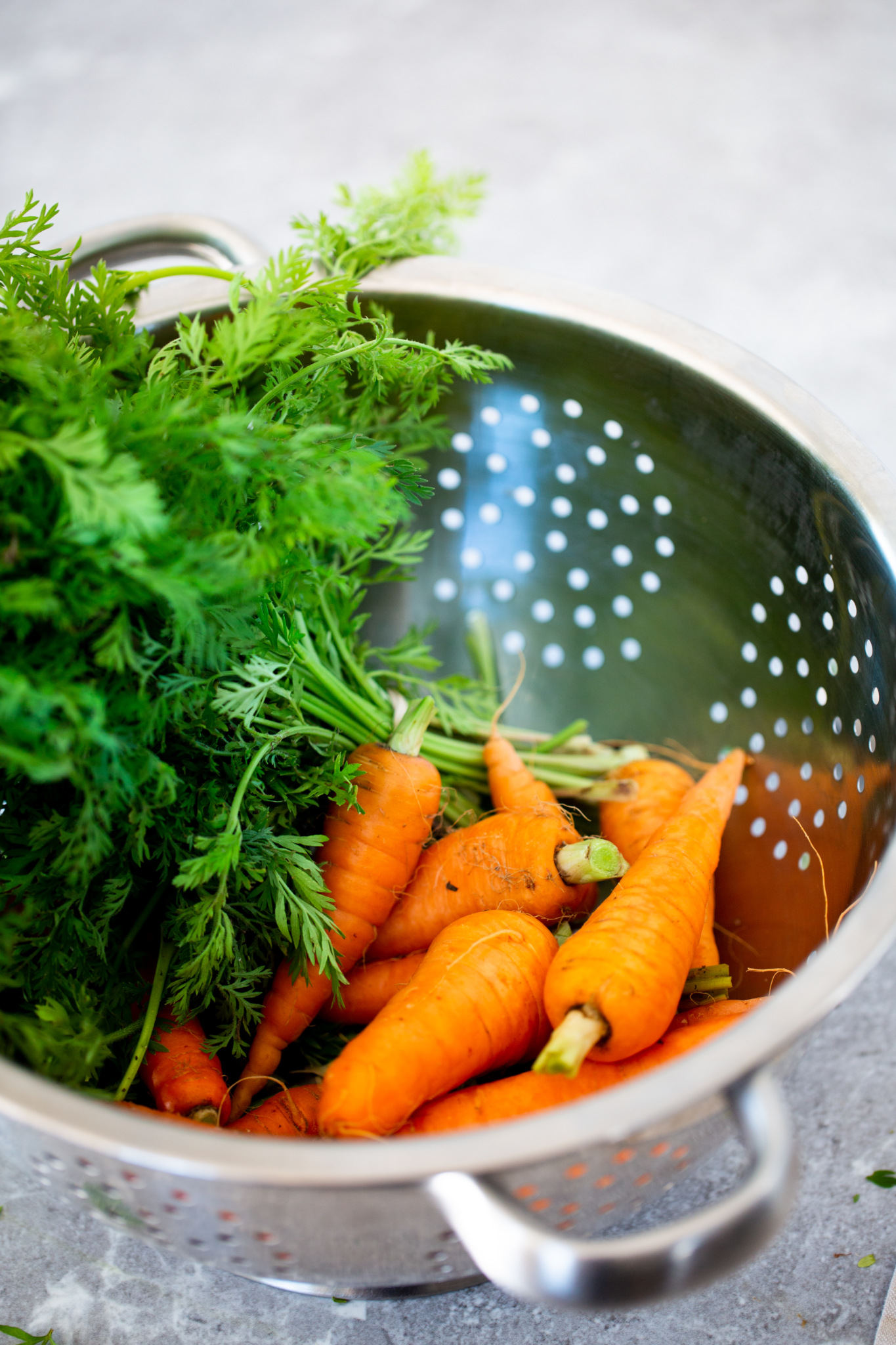 bunch of carrots in stainless steaal colander