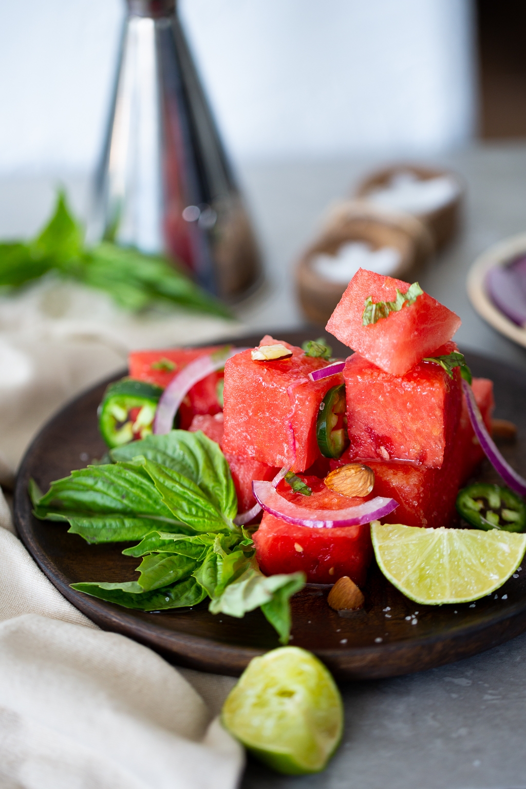 Spicy Watermelon basil salad with toasted almonds and red onion.