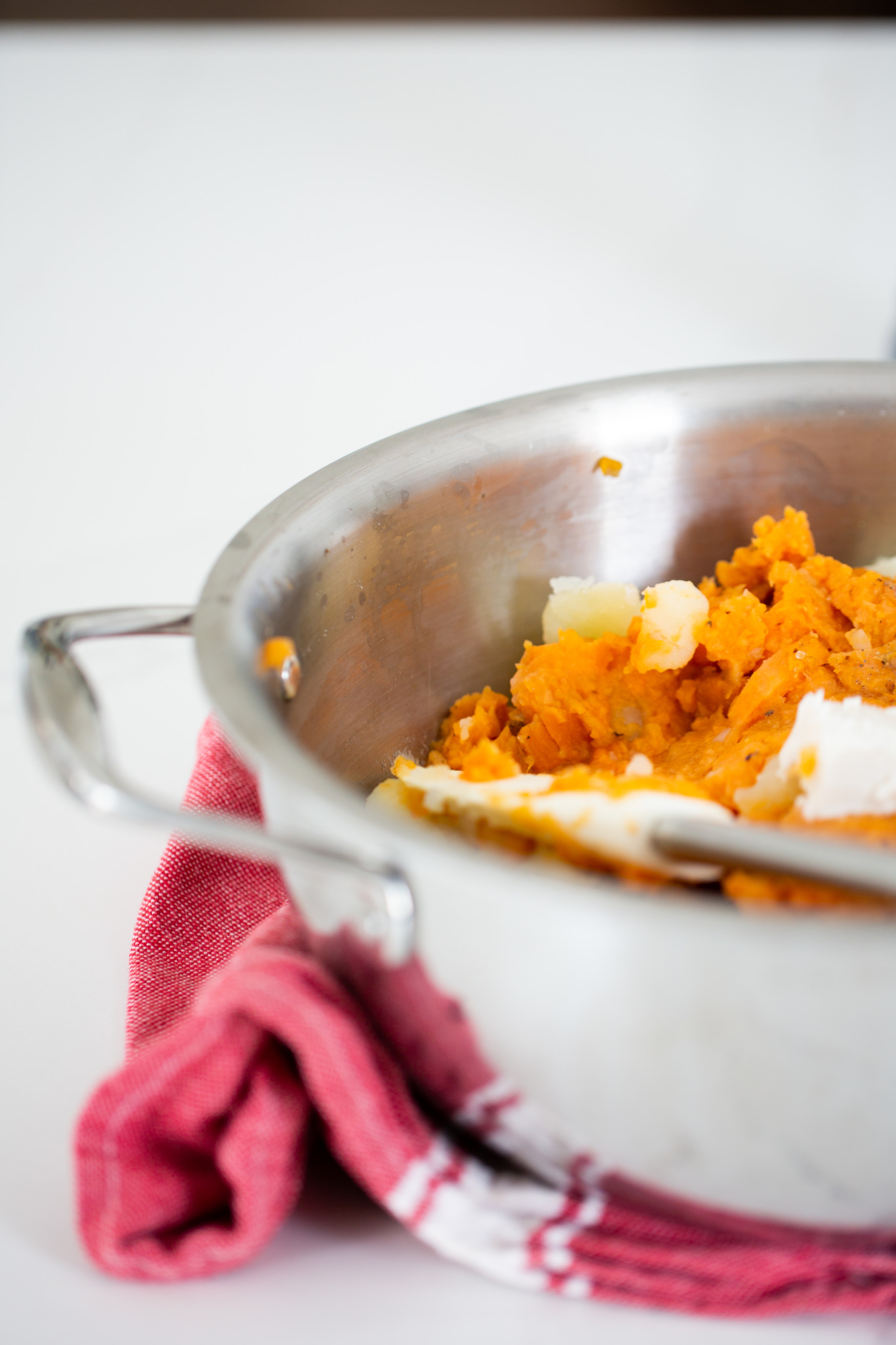 sweet potato puree with yukon potatoes in a stainless steel pot