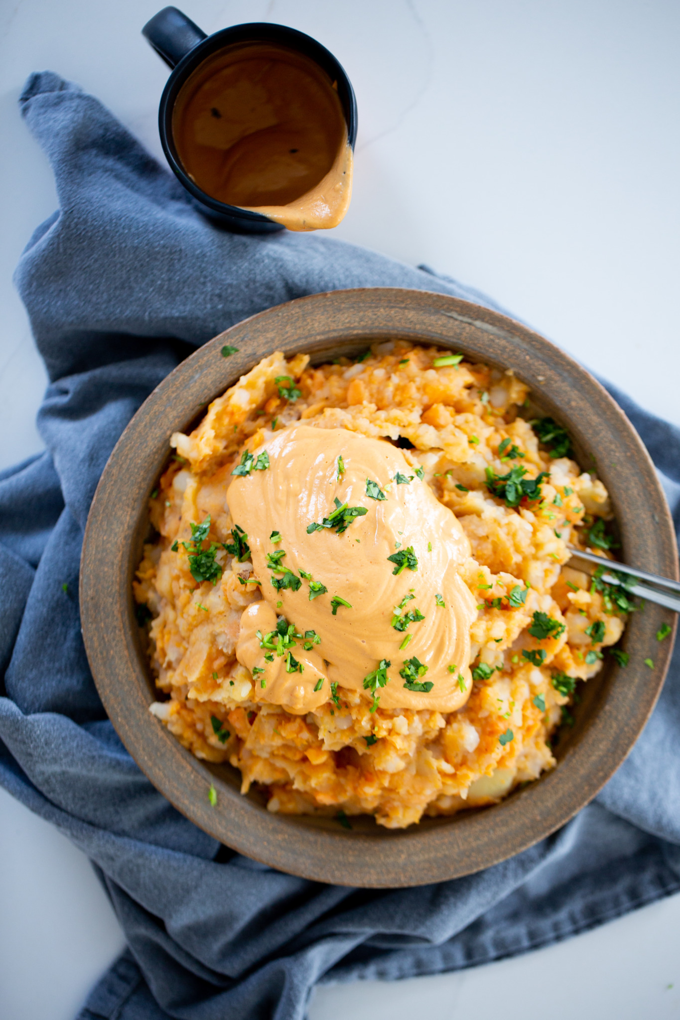 mashed potatoes and sweet potatoes with vegan chipotle queso