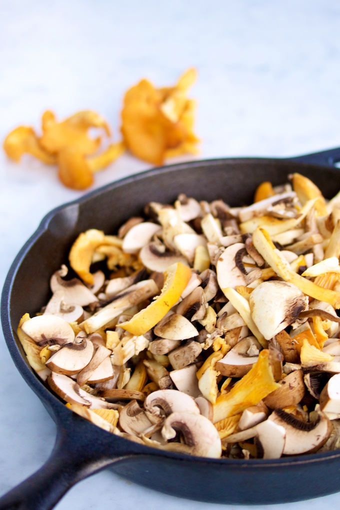 Different types of mushrooms on a skillet