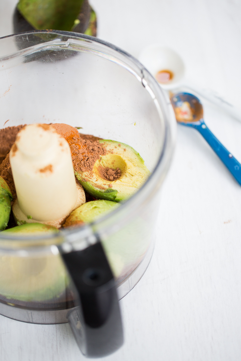 avocados and cocoa powder in food processor container
