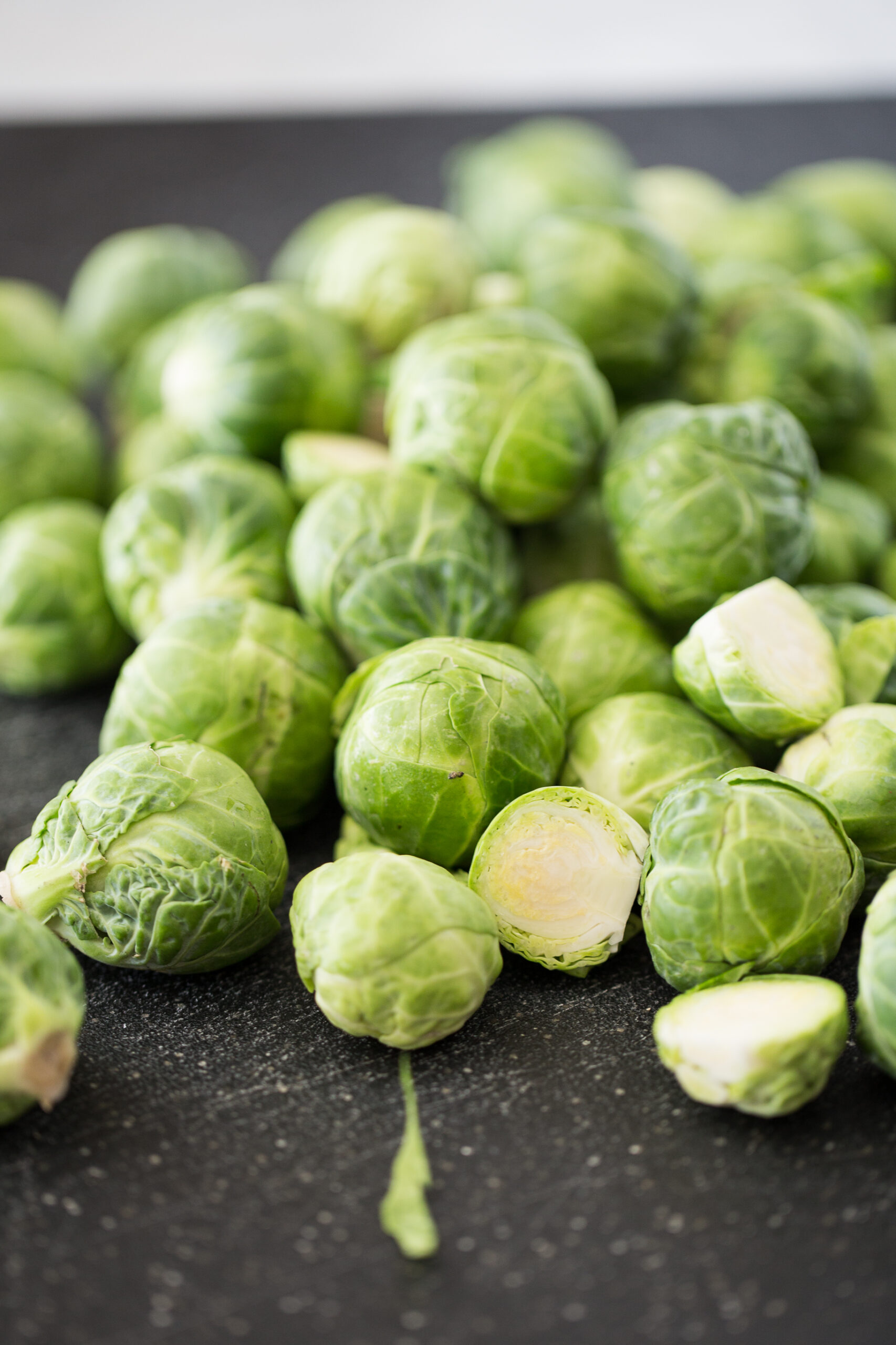 Brussels sprouts on a black cutting board