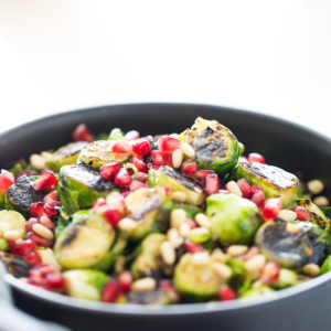 Roasted Brussels sprouts salad with agave Dijon mustard and topped with pine nuts and seeds. It is vegan and perfect for the Holidays.