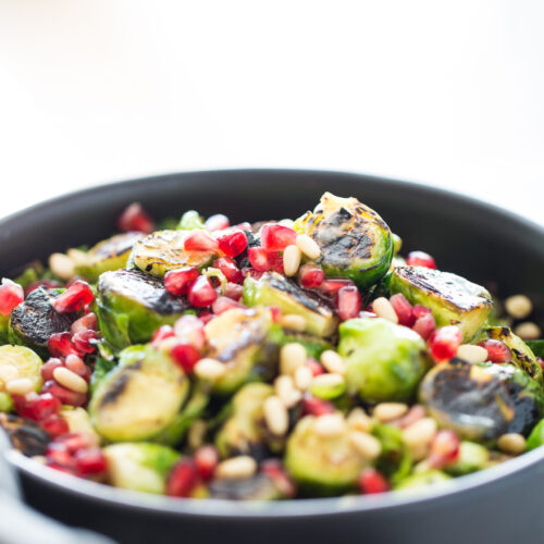 Roasted Brussels sprouts salad with agave Dijon mustard and topped with pine nuts and seeds. It is vegan and perfect for the Holidays.