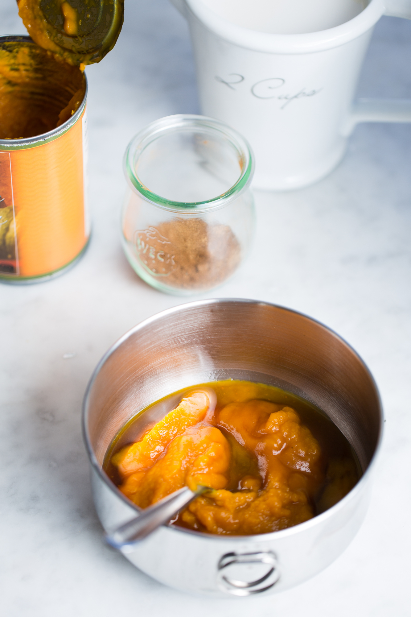 canned pumpkin n a bowl with other ingredients to make baked oats casserole