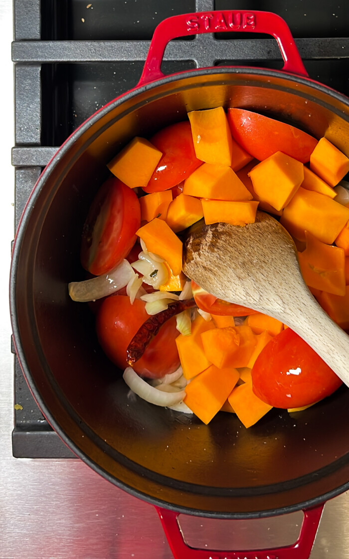 onion, garlic, butternut squash and tomatoes in a dutch oven