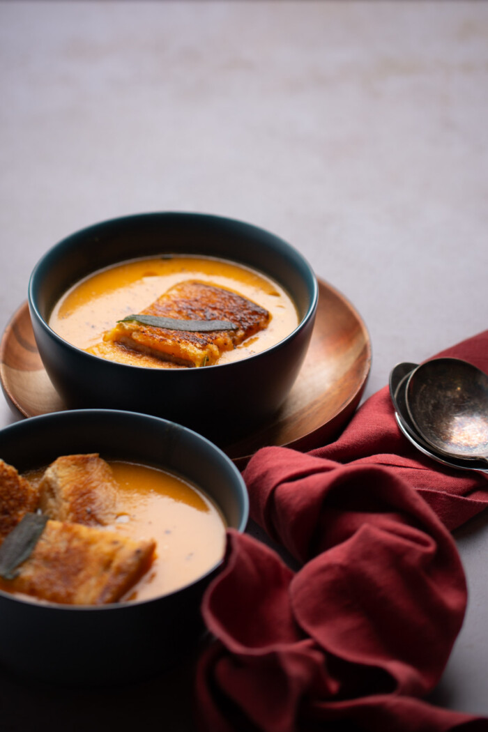 three bowls with buttrnut squash soup without coconut milk topped with grilled cheese 