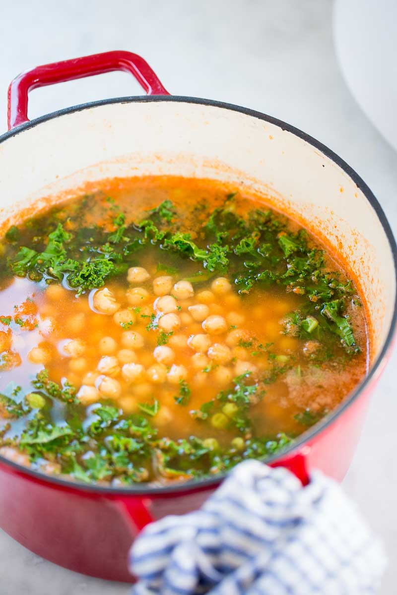 Red cast iron pot with mexican vegetable soup