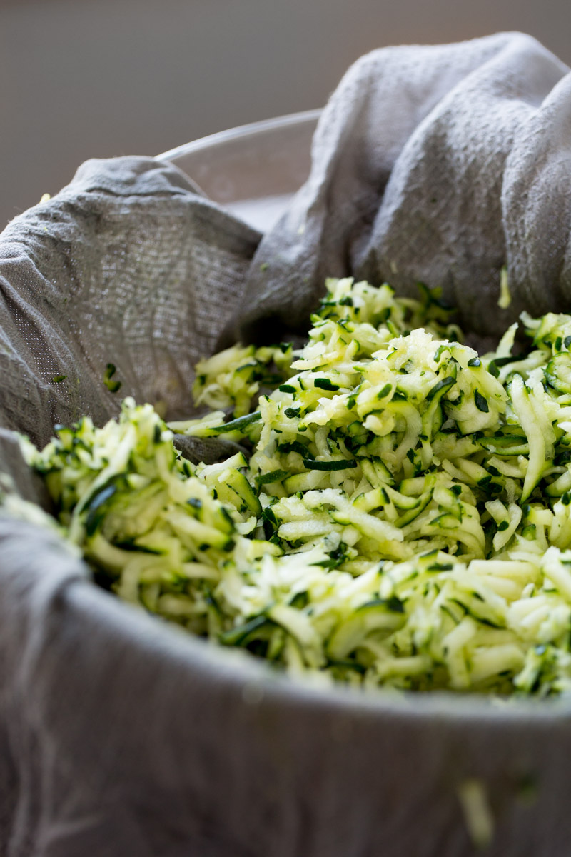 Grated zucchini over an old kitchen towel