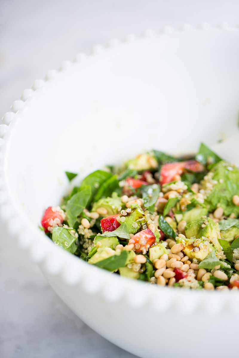 Spinach, quinoa, avocado and strawberries in a salad bowl