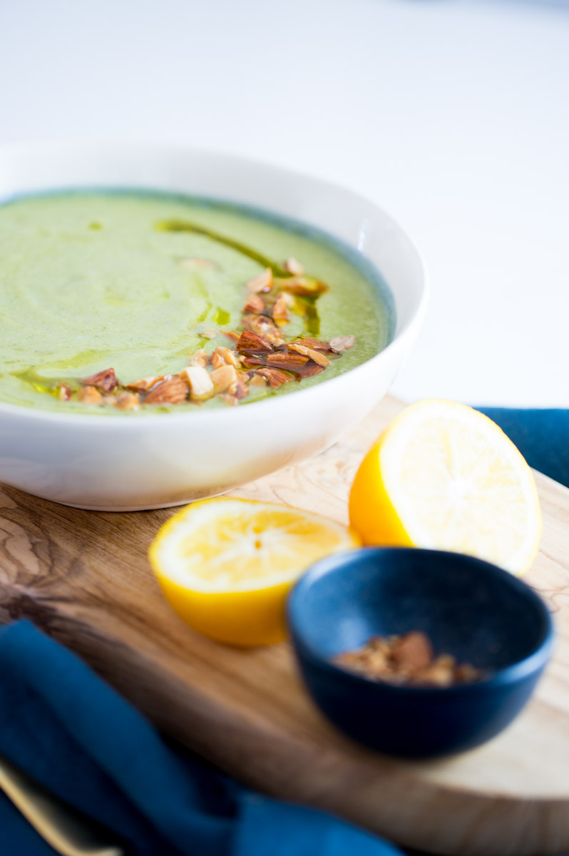 Broccoli and zucchini soup with almonds, olive oil and lemon juice