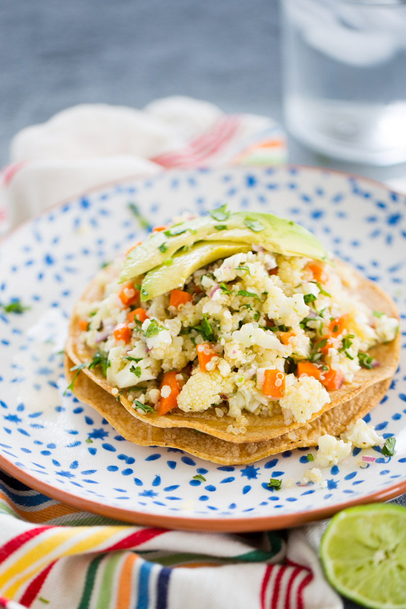 vegan ceviche tostada over a white and blue dish