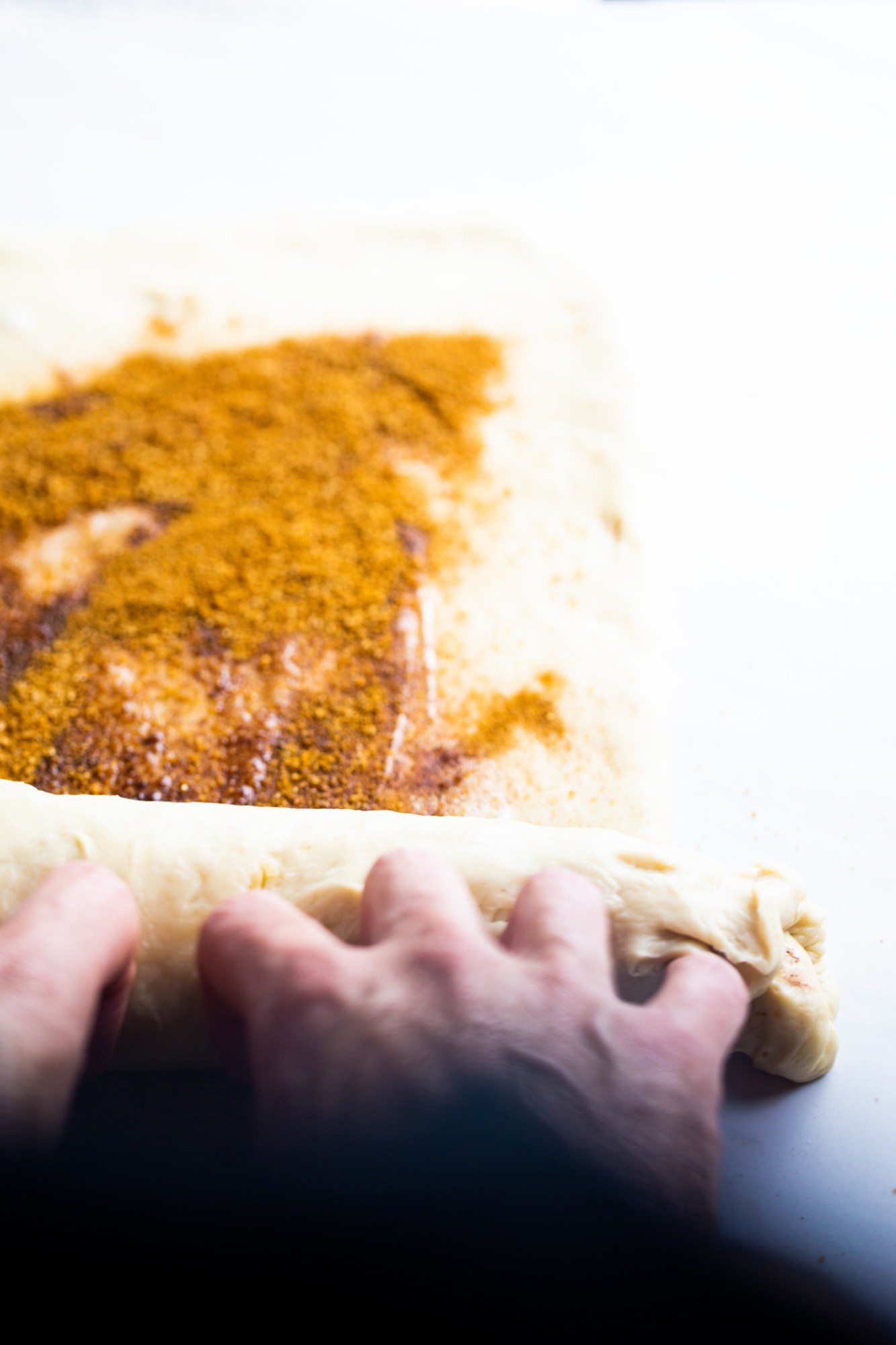 rolling a batch of dough for vegan cinnamon rolls