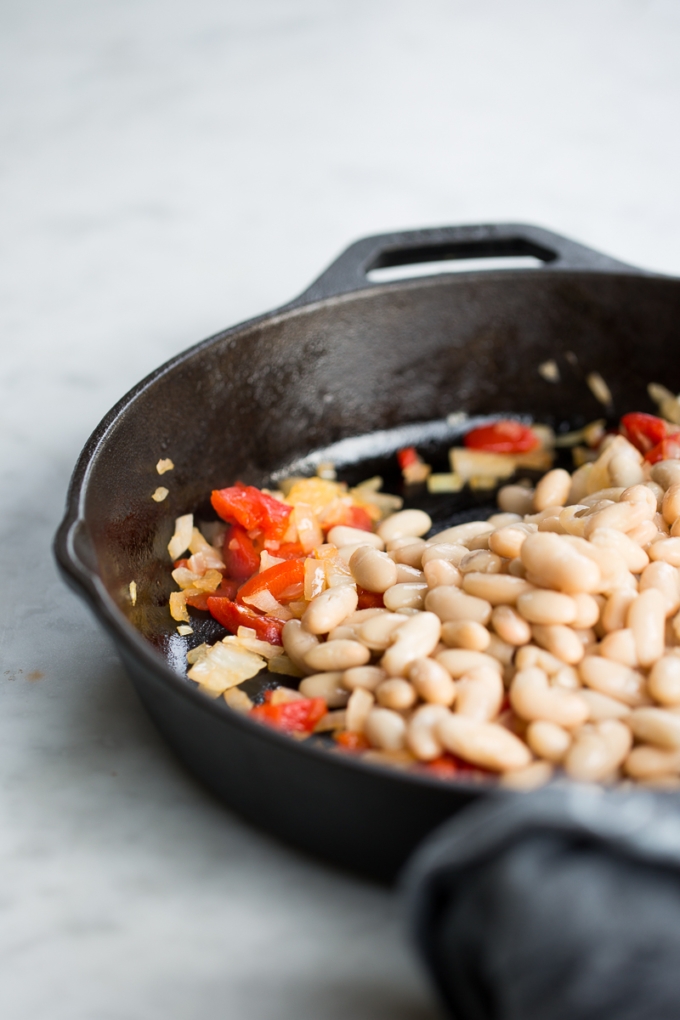 navy beans with onions on cast iron skillet