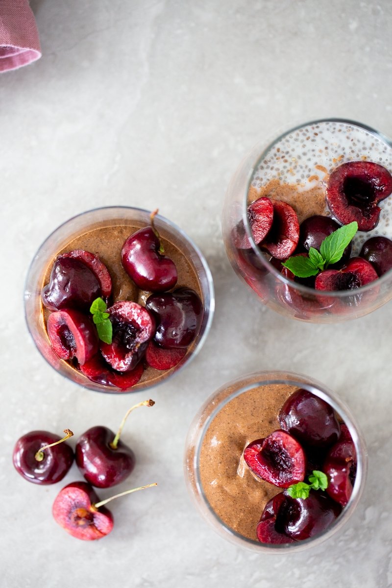 Three-layer chia pudding topped with cherries