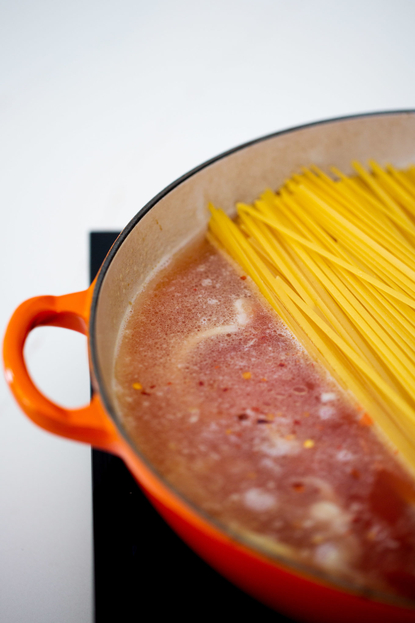 Pasta in a pan being cooked