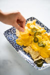 Queso vegano para nachos en nachos con chiles jalapeños