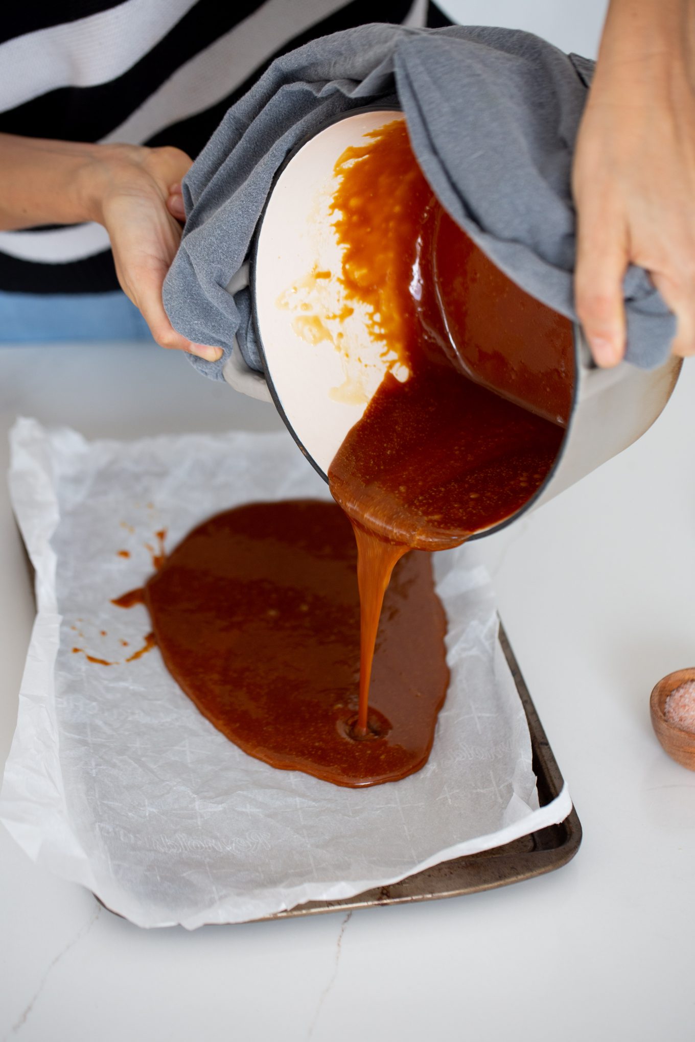 pouring the hot caramel onto a tray