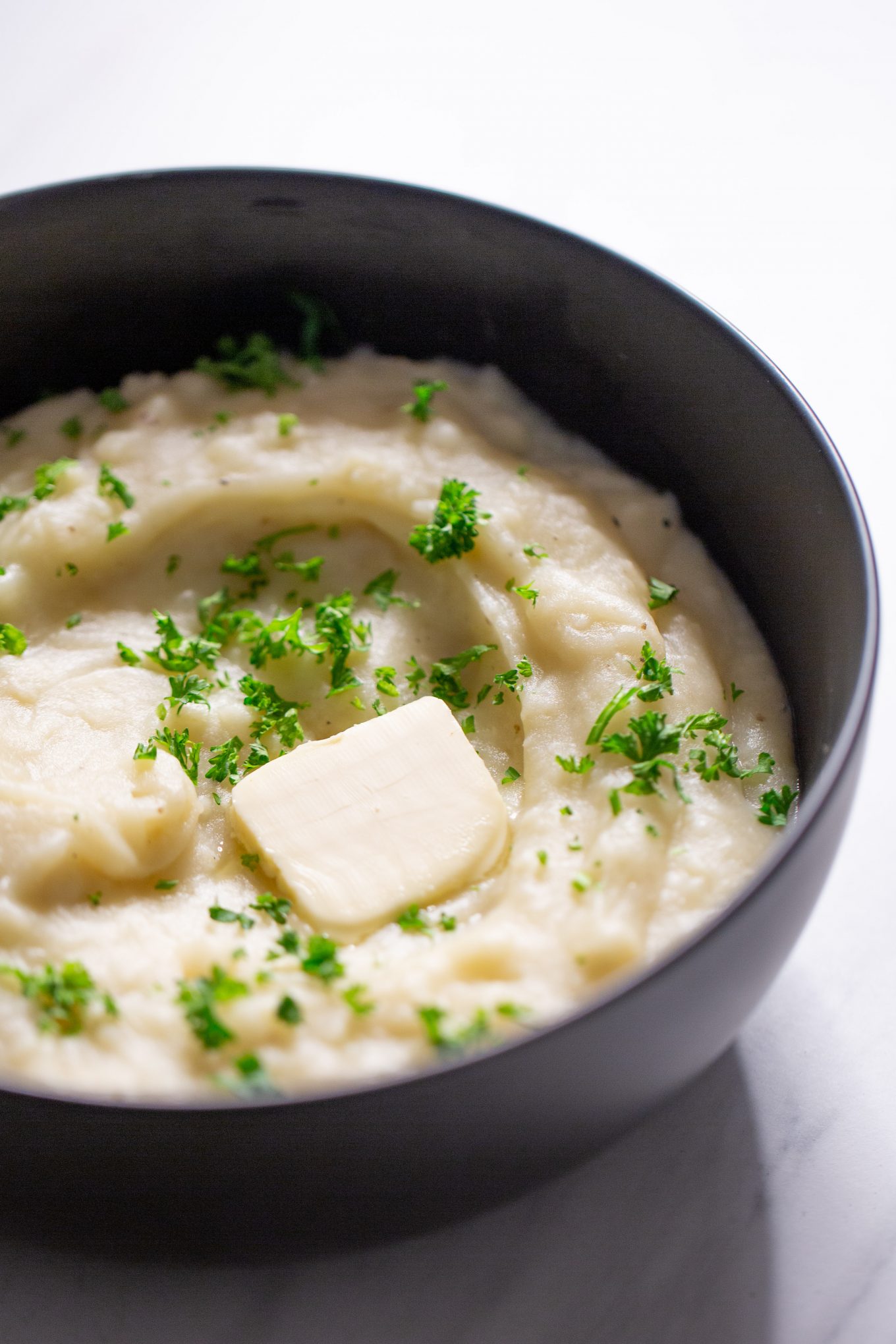 Vegan mashed potatoes in a black bowl