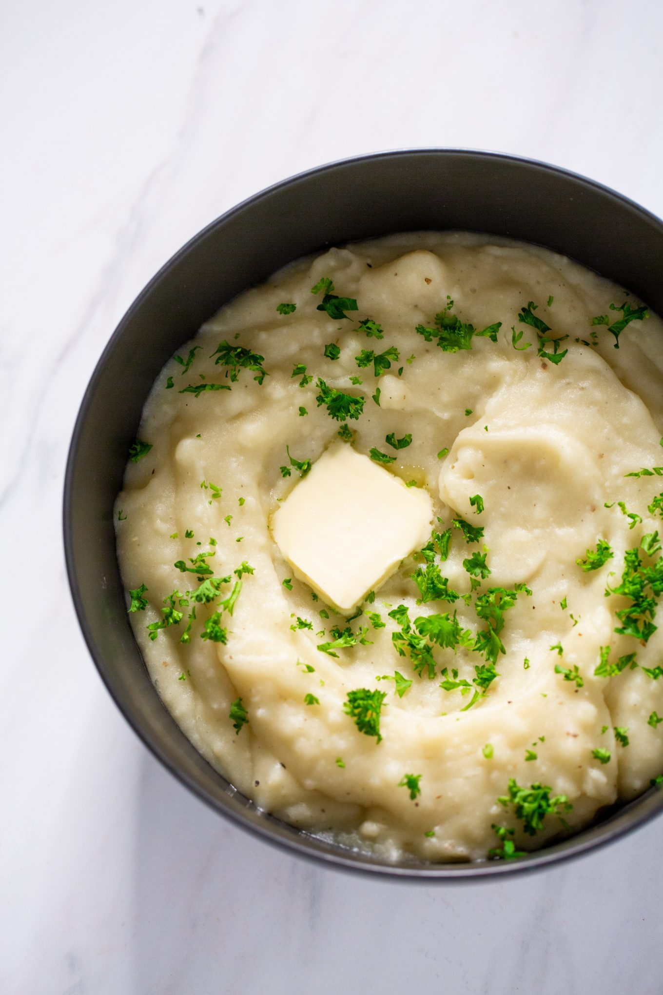 vegan mashed potatoes with a slice of vegan butter