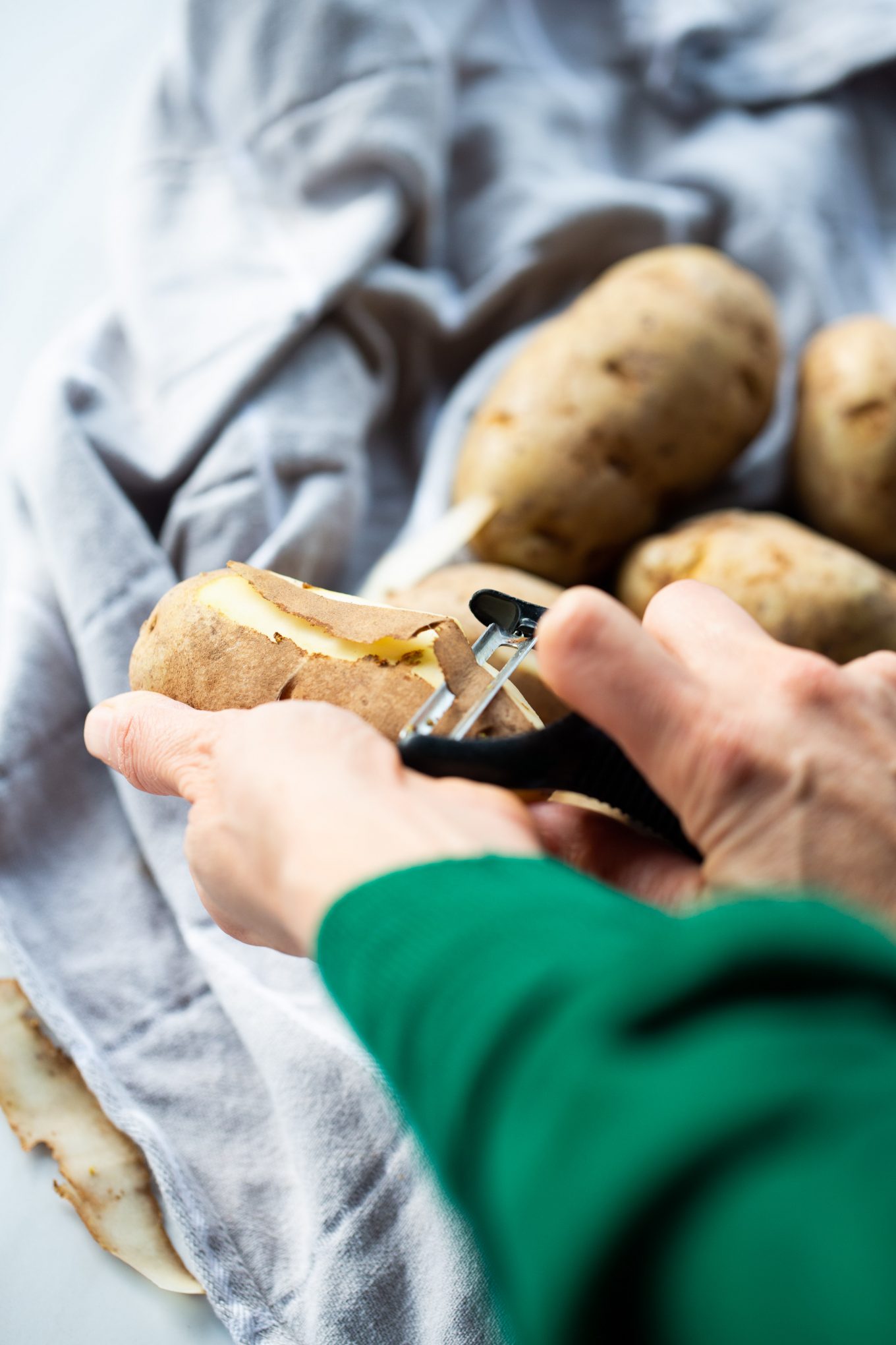 peeling potatoes with a vegetable peeler