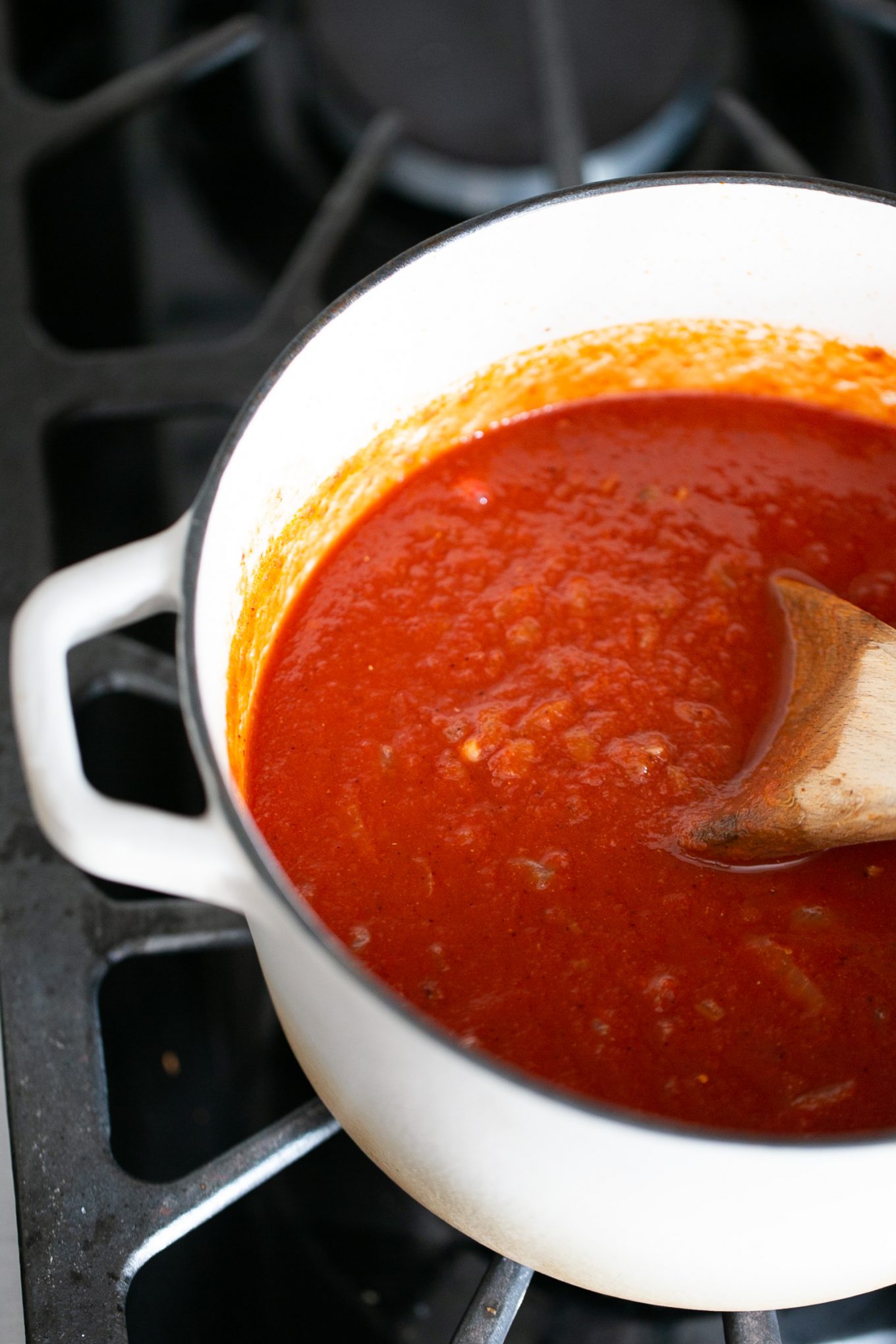 Vegan homemade red enchilada sauce simmering on the stove