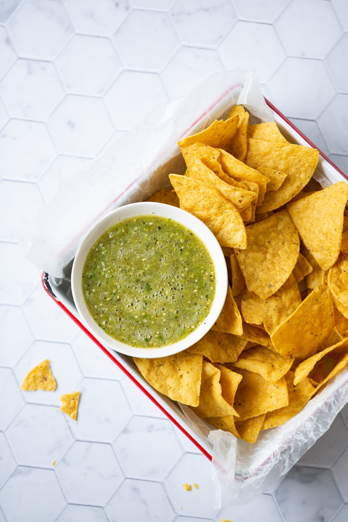 tray of chips and a bowl of authentic mexican salsa verde