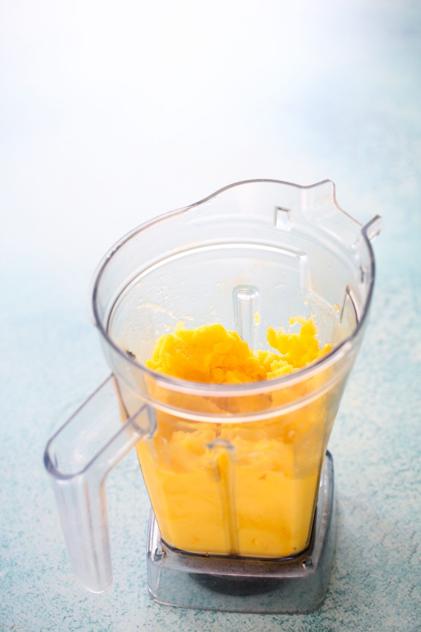 Pureed mango in the blender container