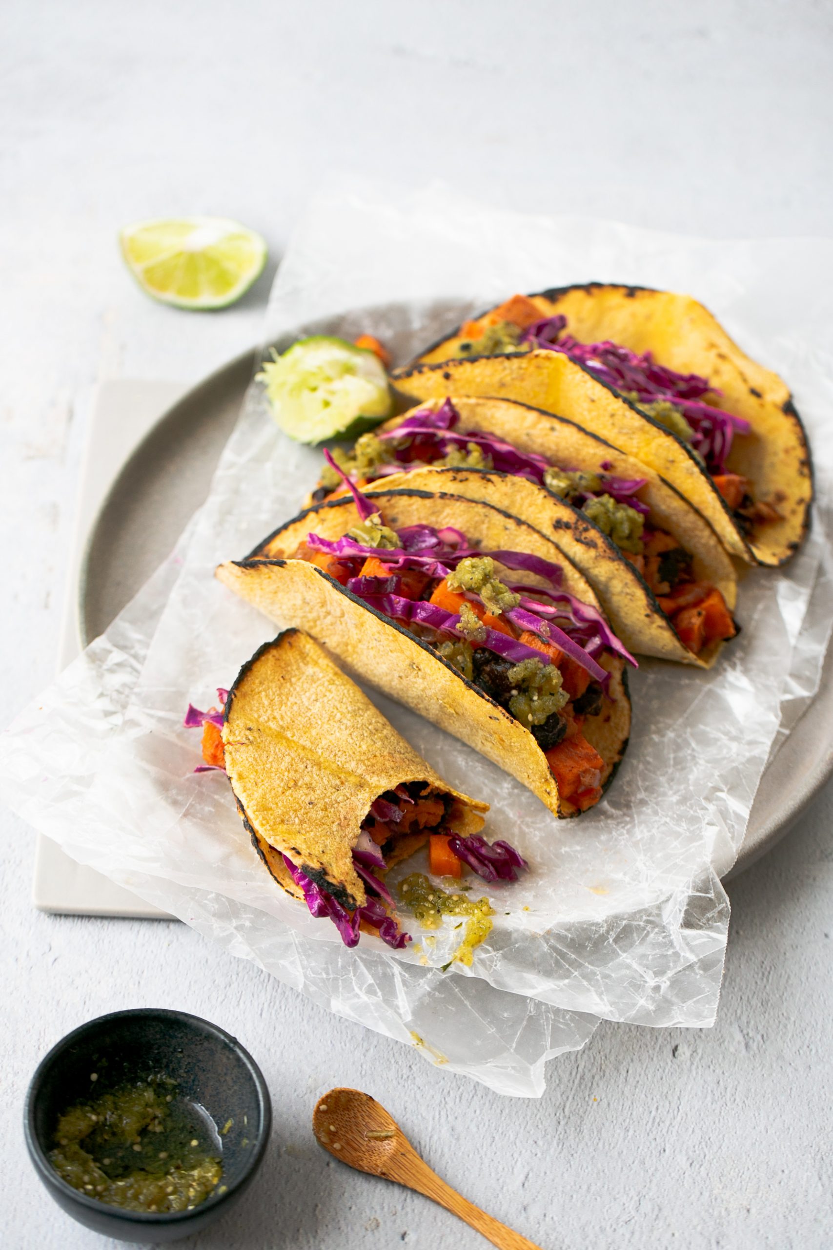 4 corn tortilla tacos with sweet potatoes, black beans and purple cabbage