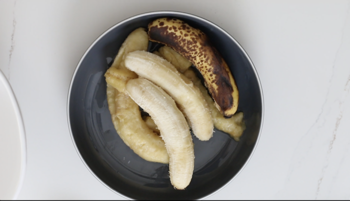 Over ripe bananas in a grey bowl