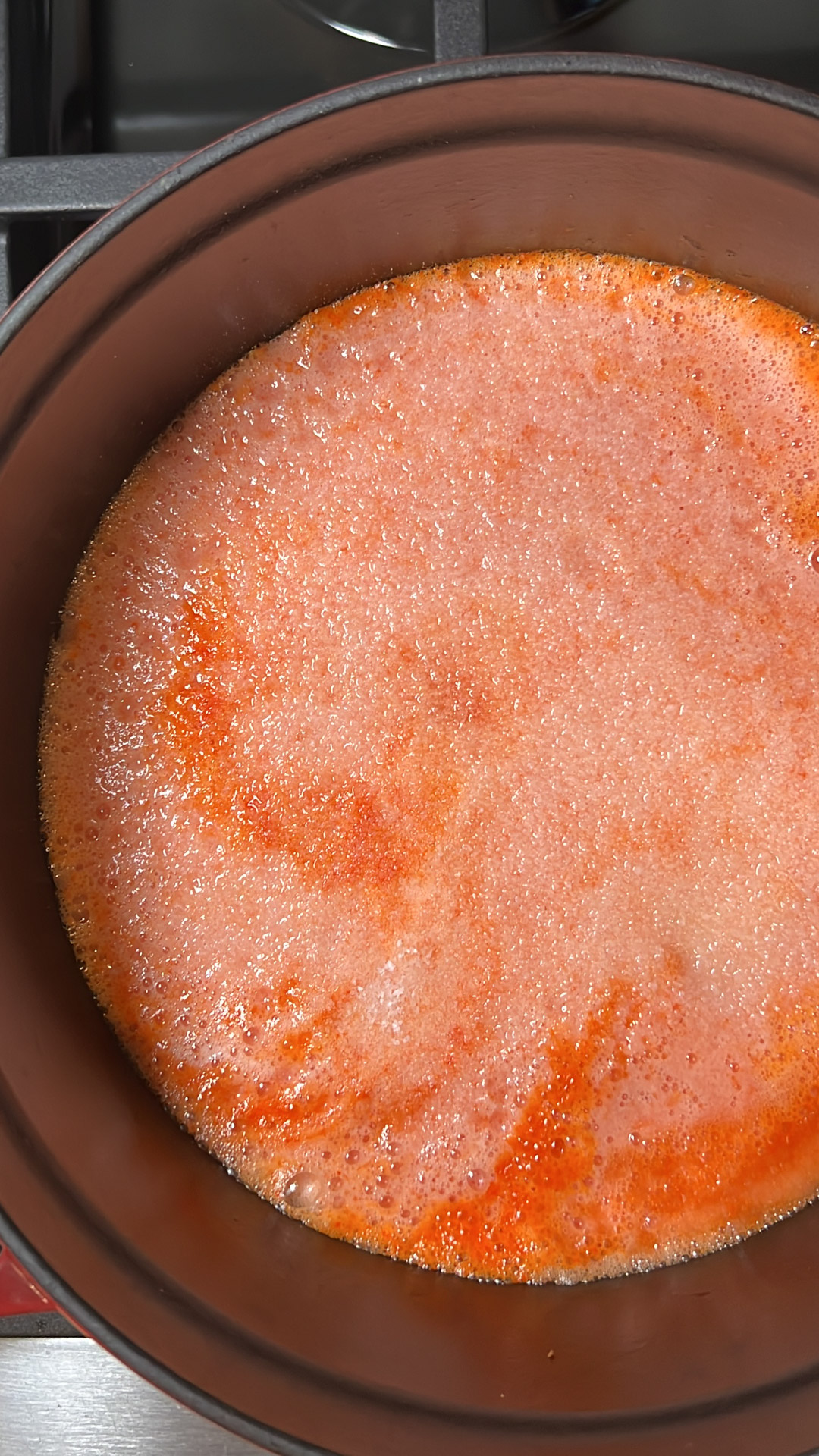 tomato broth in a soup pot.