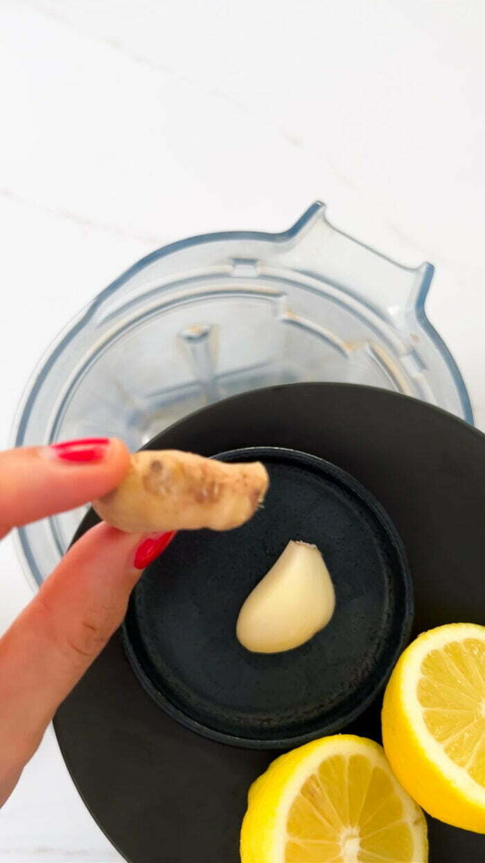 Adding garlic and ginger to the blender