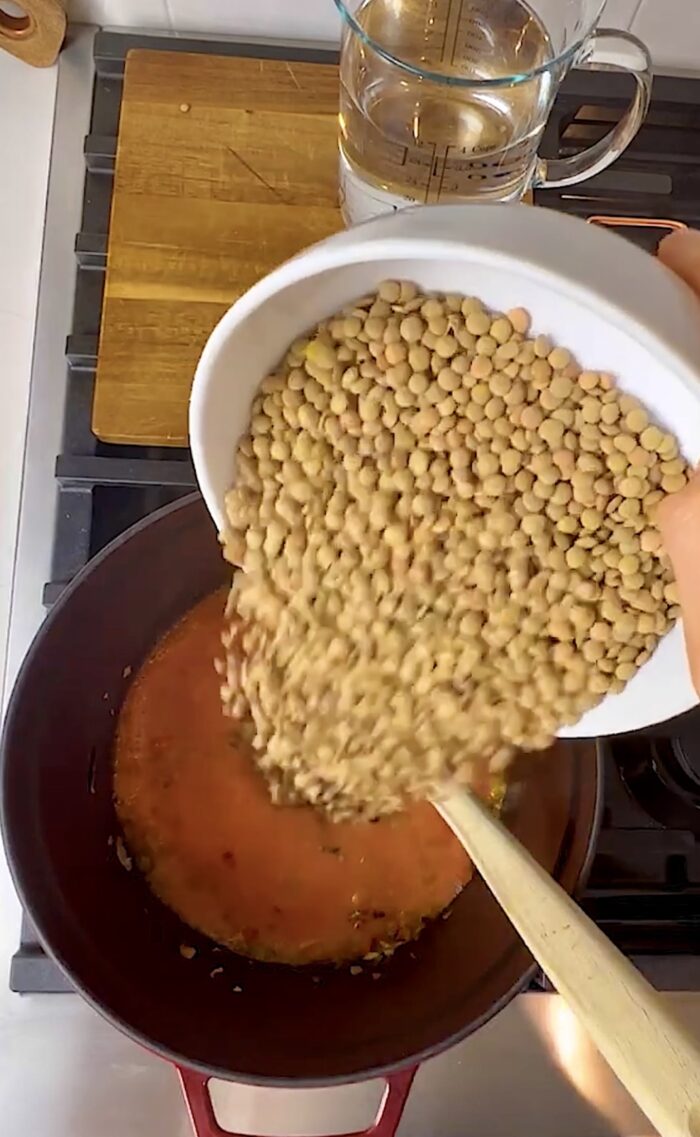 pouring dried green lentils into the bowl.