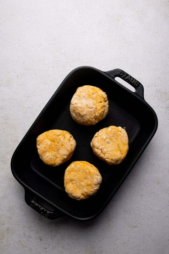 four dinner rolls on a baking pan